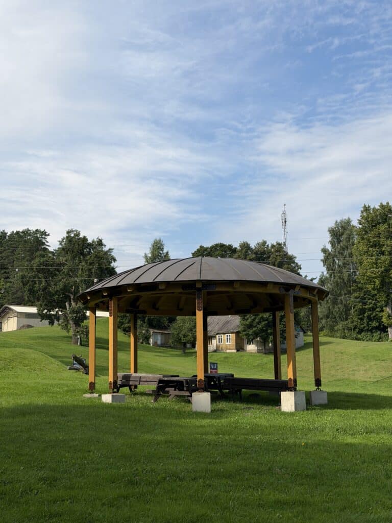 A picnic area with benches and a shelter in Ramkalni Park.