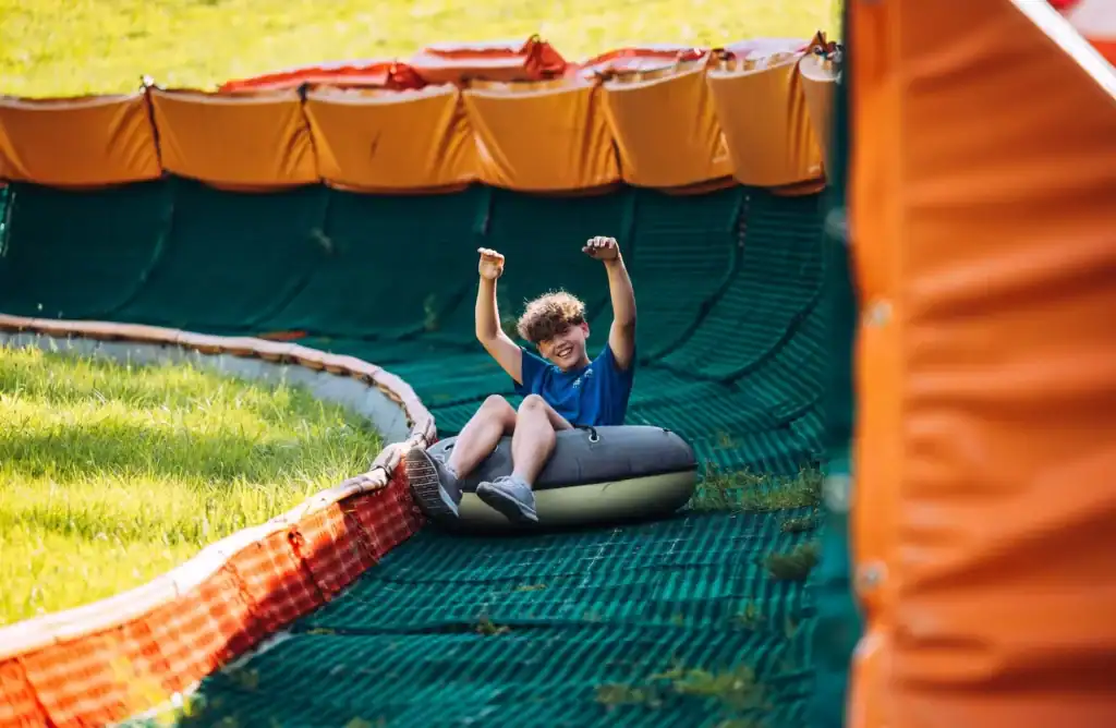 A child on a slide, happy and active, a children's playground.