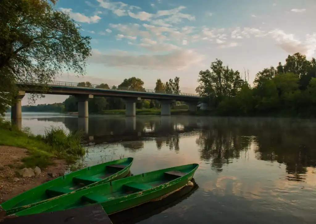 Scenery with boat and bridge by the pond, view of nature.