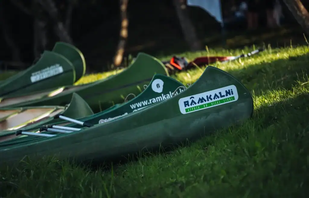 Kanōe boats on green grass, recreational and sports equipment.