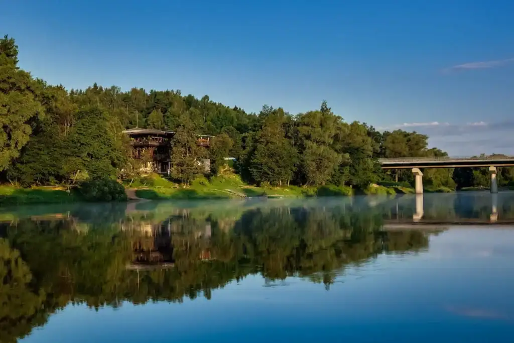 Natural landscape with lake, bridge and green trees, a relaxing natural scene.