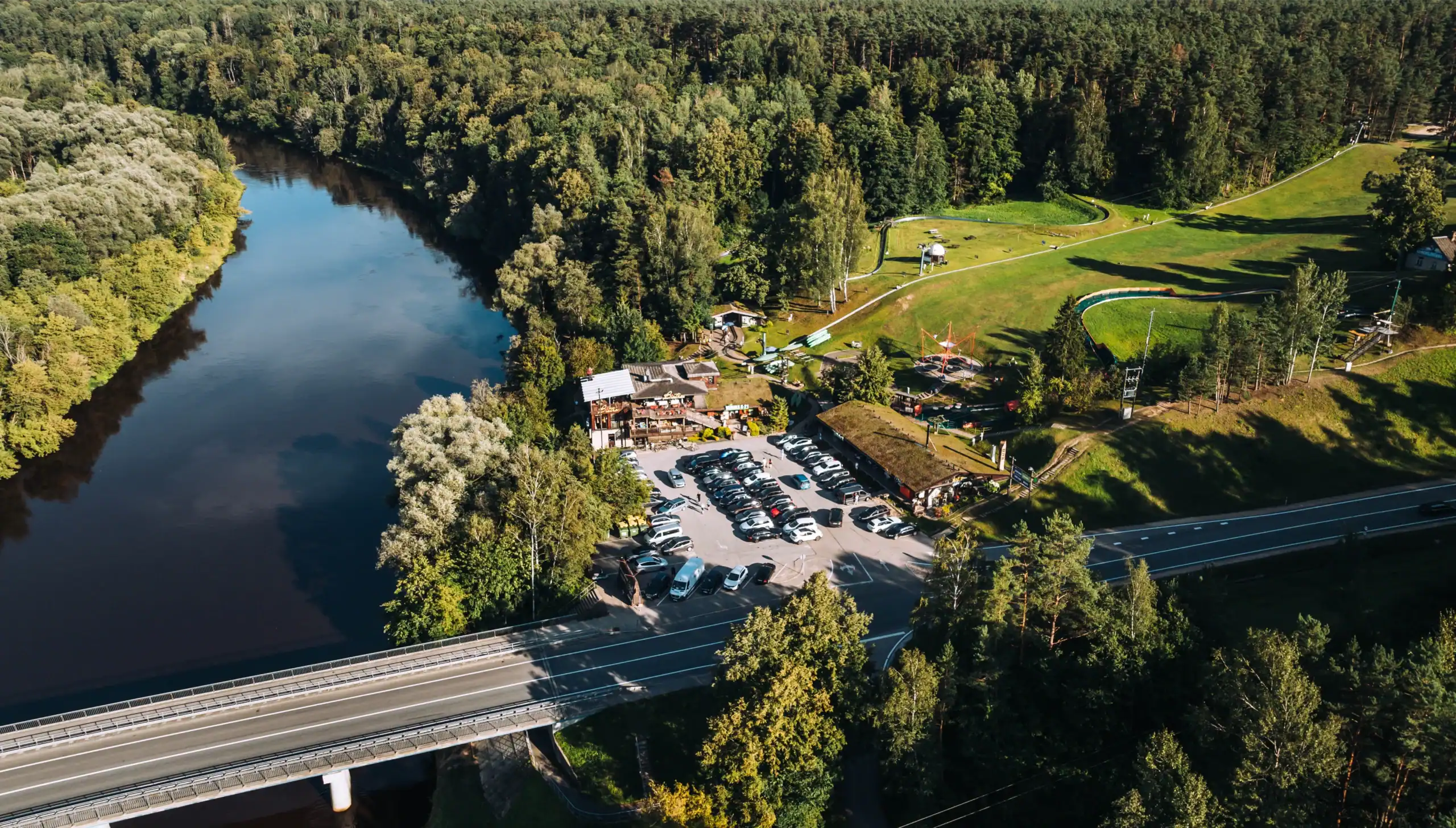 A natural landscape featuring a lake, a forest and the Ramkalni recreation area – the beauty of Latvia’s countryside.