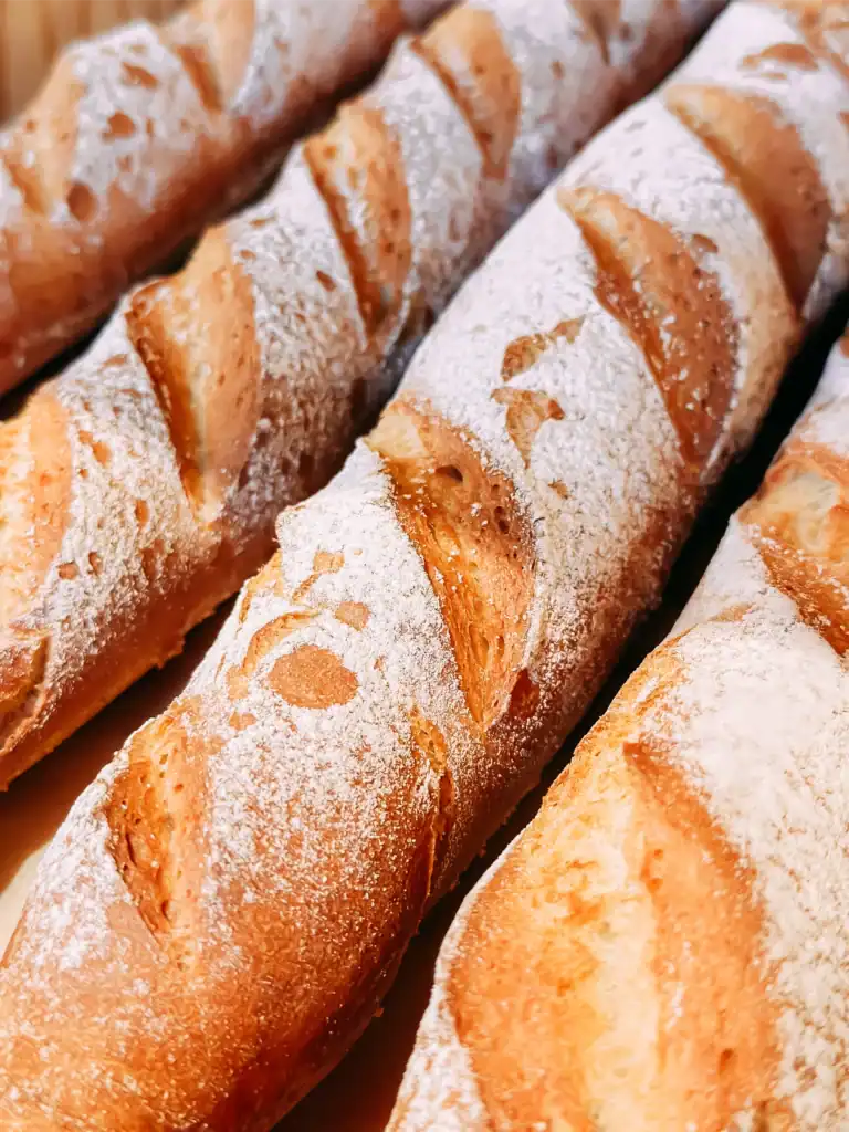 Bread rolls with a crispy crust and icing sugar, fresh and delicious.