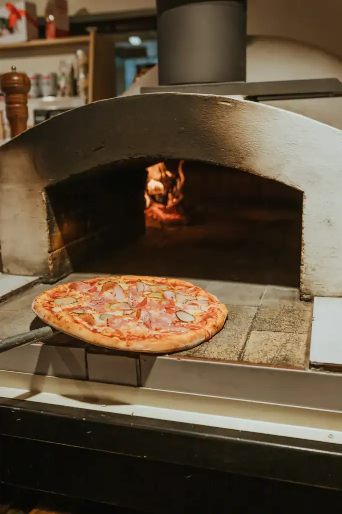 Making pizza in a wood-fired oven in Ramkalni.