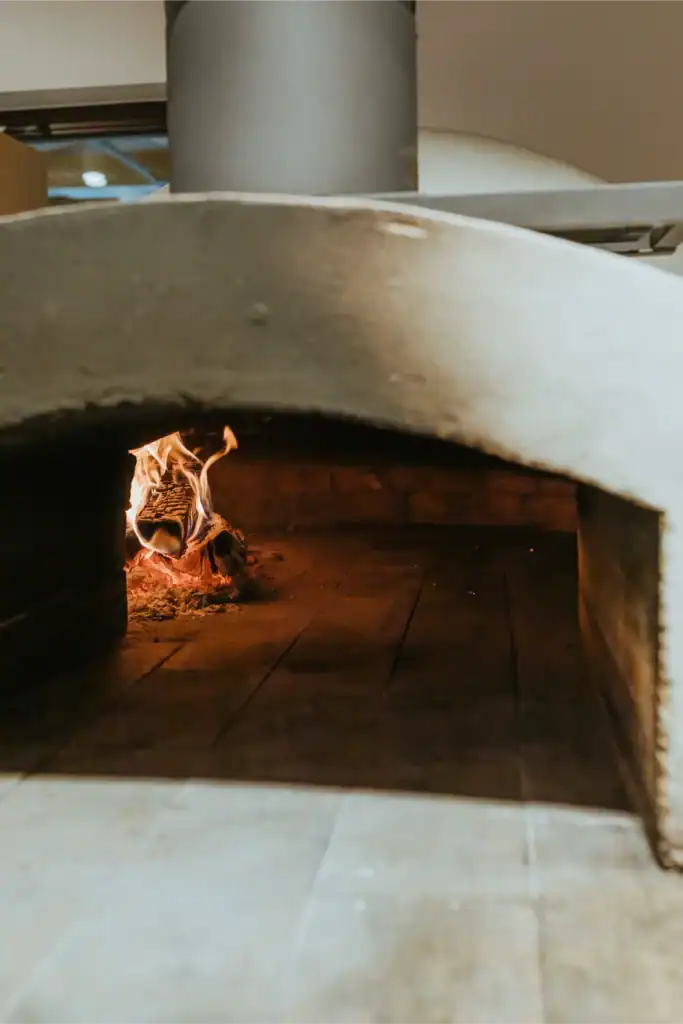 A modern pizza oven with a door and a fan, ideal for baking pizzas.