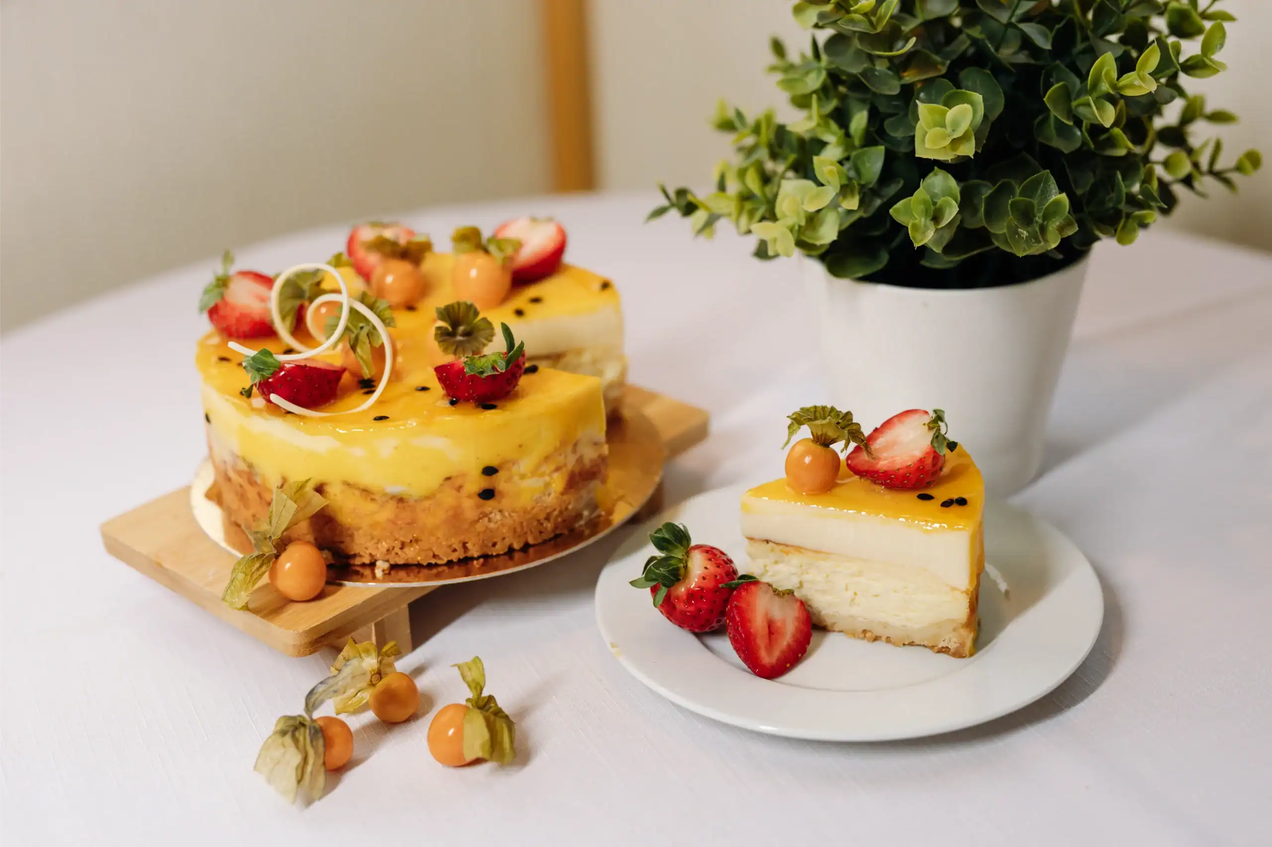 A fruit and cream cheese cake with strawberries, decorated with berries and herbs.
