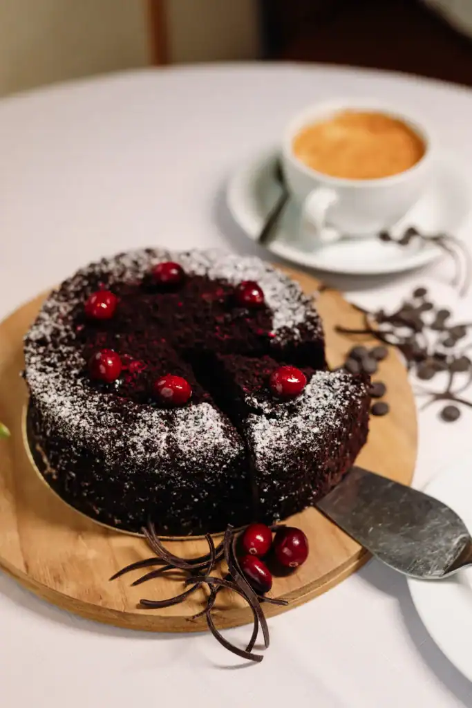 An ice-cream cake with berries, chocolate decorations and icing sugar – the perfect choice for dessert.