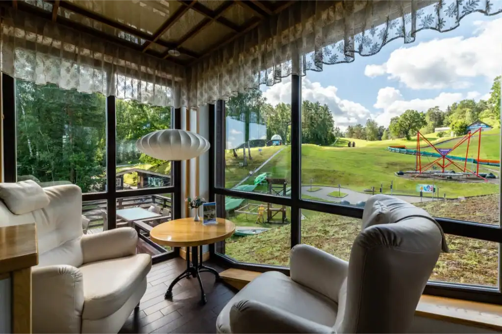This garden-view guest room offers panoramic windows and a seating area.