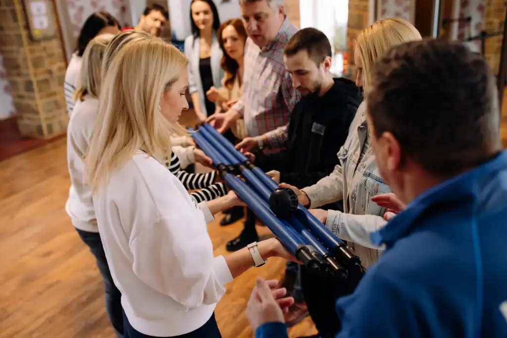 Groups of people play indoor games, activities for children and adults.