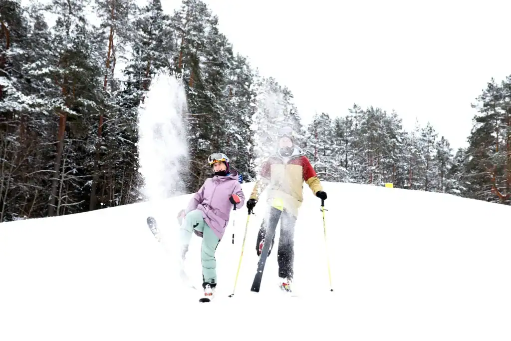 Three people skiing in the snow in the middle of a forest with trees in the background.