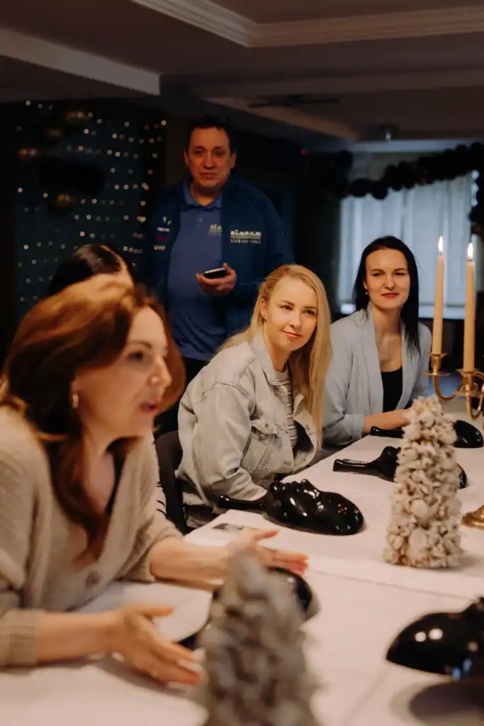 People in the group play indoor game activities sitting at a table.